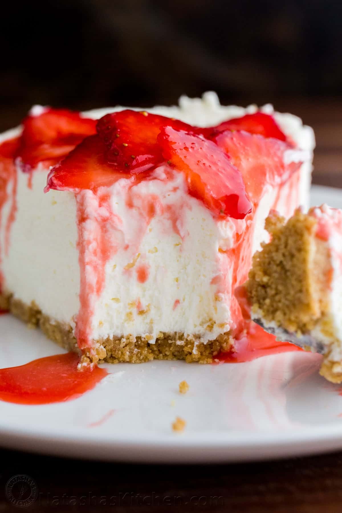 Slice of no bake cheesecake topped with strawberries