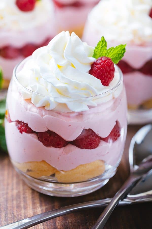 Individual serving of raspberry mousse in a cup with spoons