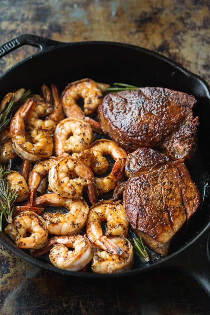 Surf and turf dinner cooked in a black cast iron pan
