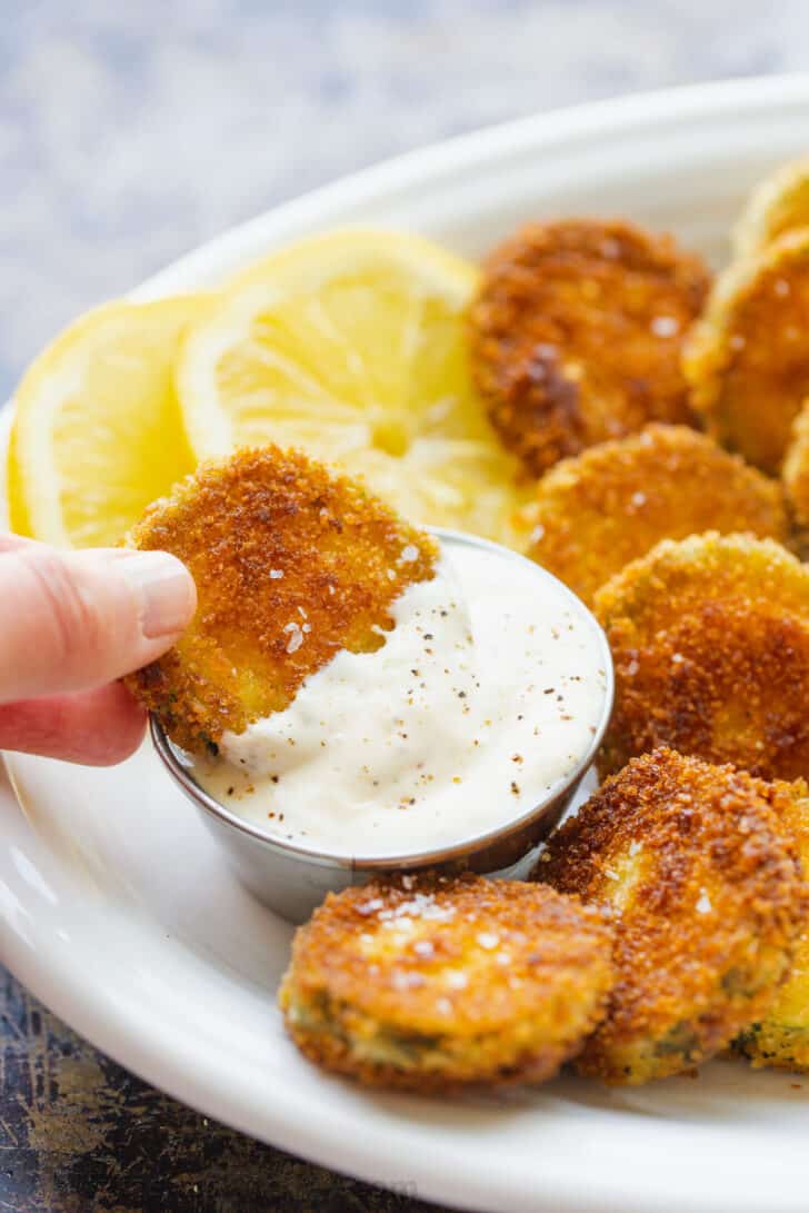 Serving fried zucchini bites with dipping sauce