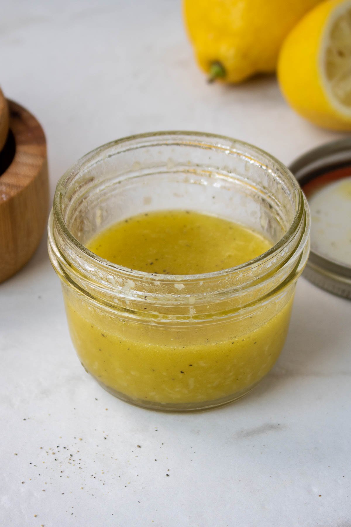 Lemony dressing for quinoa and chickpea salad in a mason jar.
