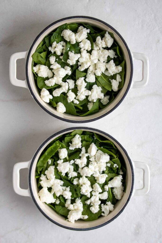 Ramekins filled with spinach and goat cheese.