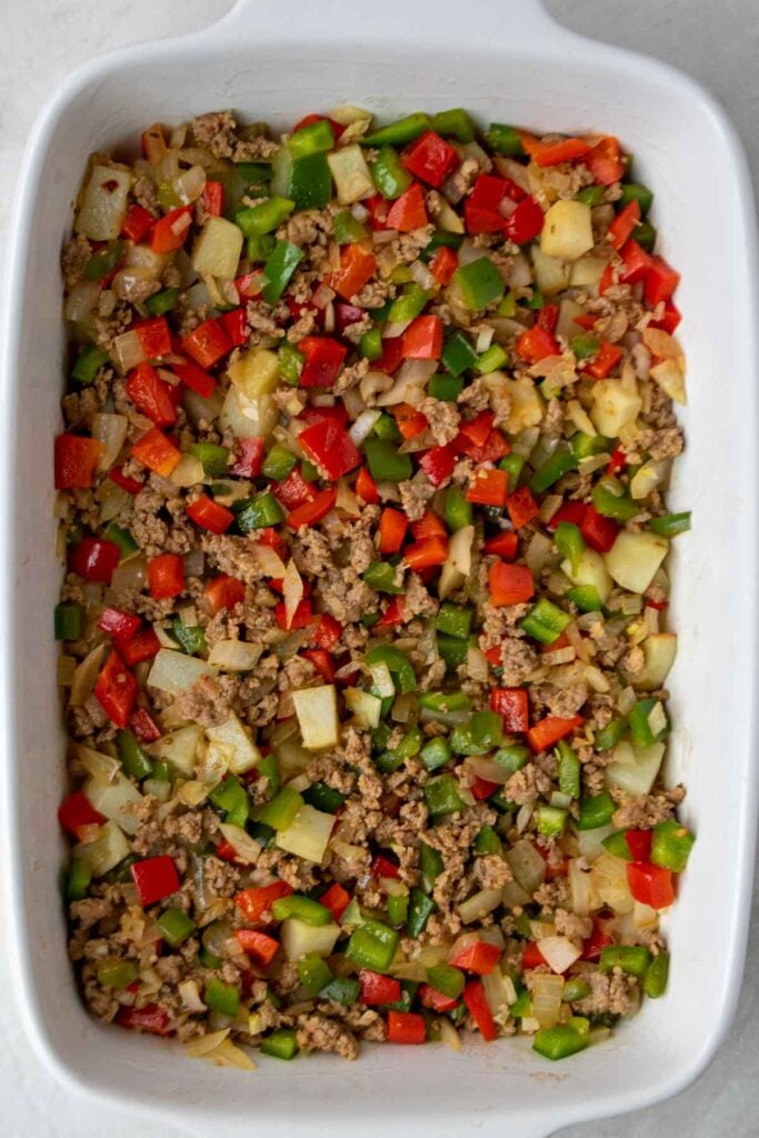 Cook potatoes, ground sausage, onion, and bell pepper in a casserole dish