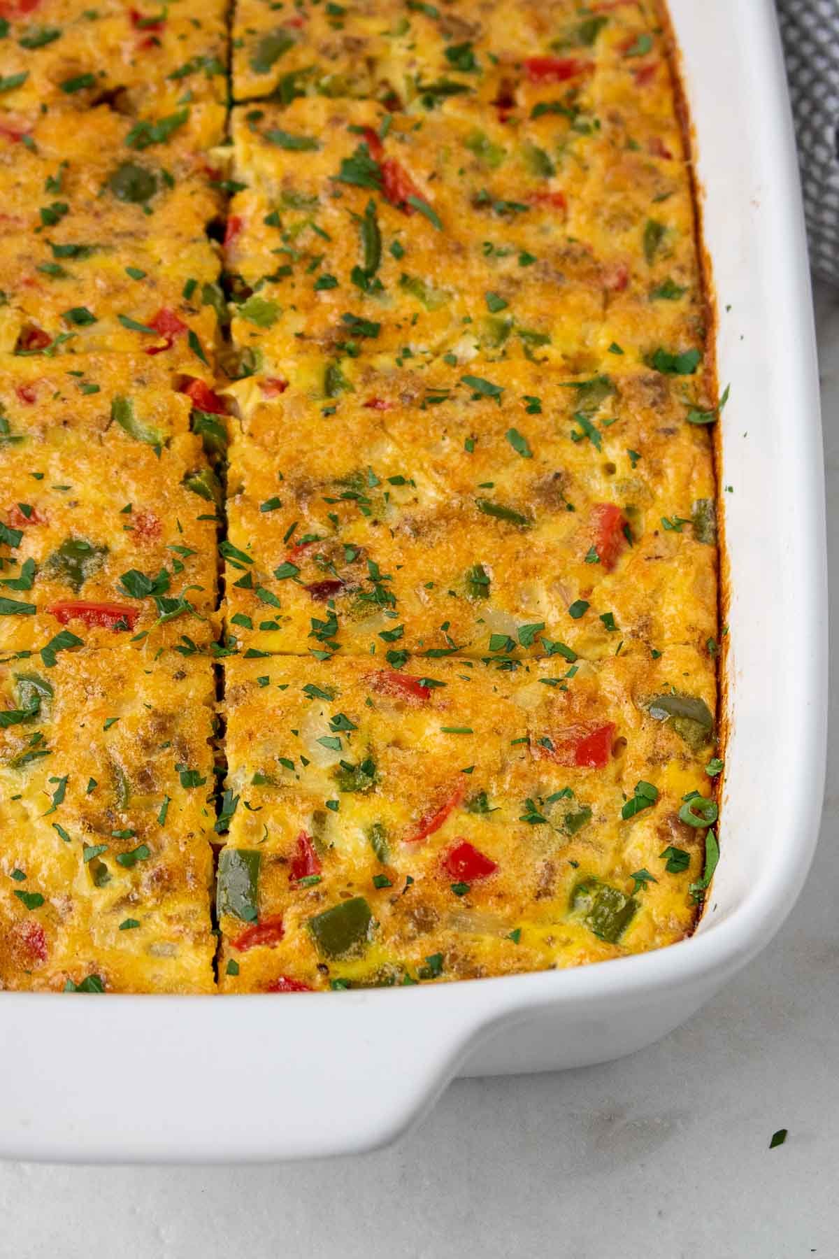 Cooked breakfast egg bake casserole in a dish sliced and ready to eat
