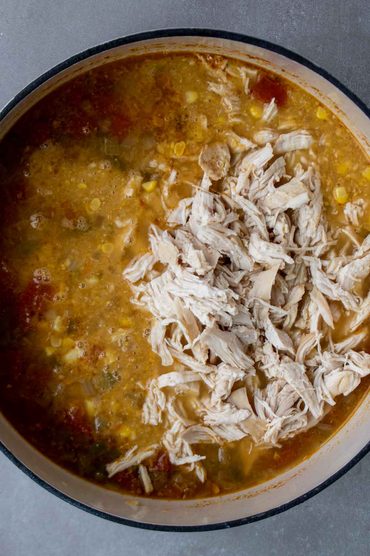 Corn soup with shredded chicken in a pot.