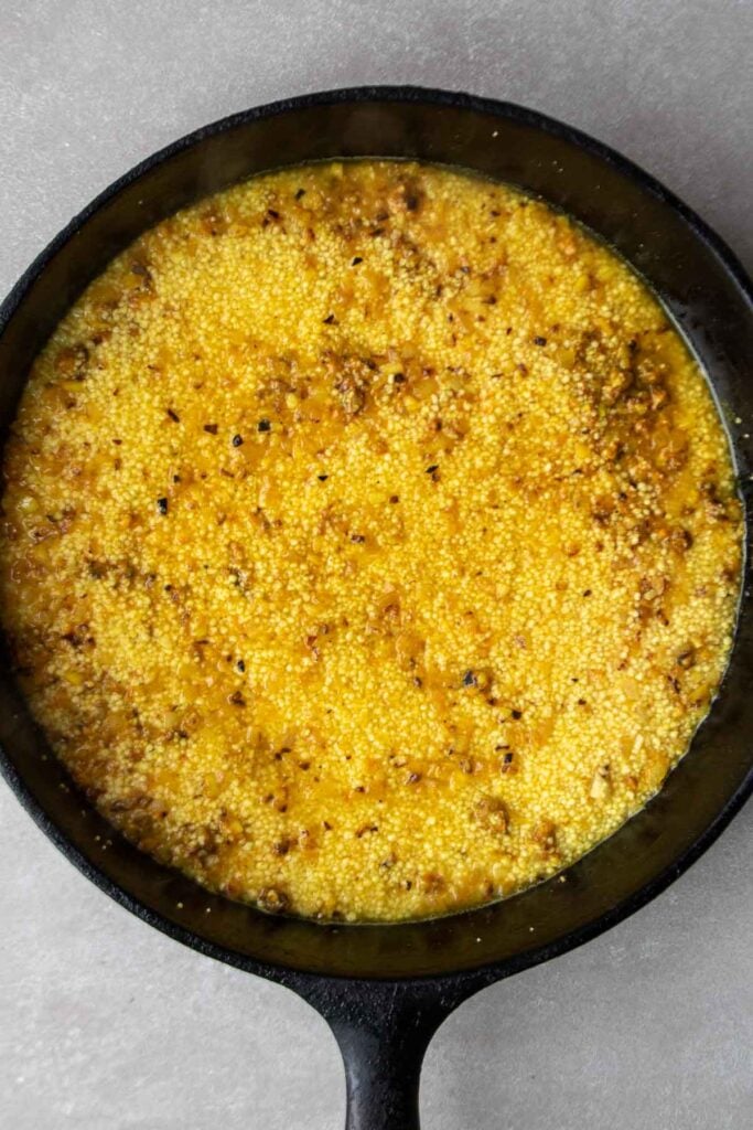 Couscous and broth in cast iron skillet