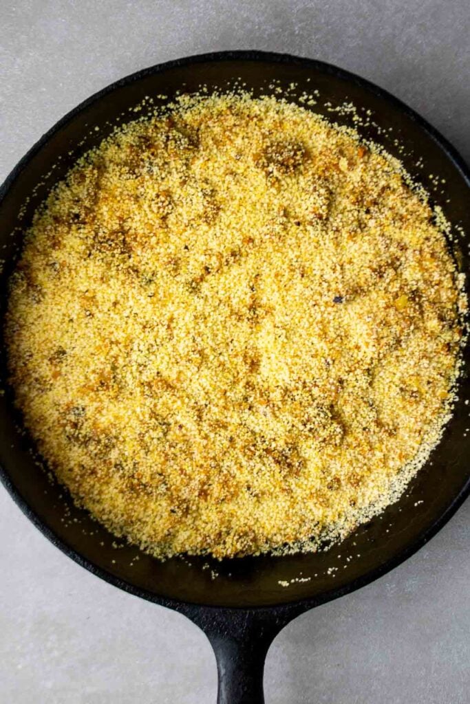 Couscous, onion, and garlic in cast iron skillet