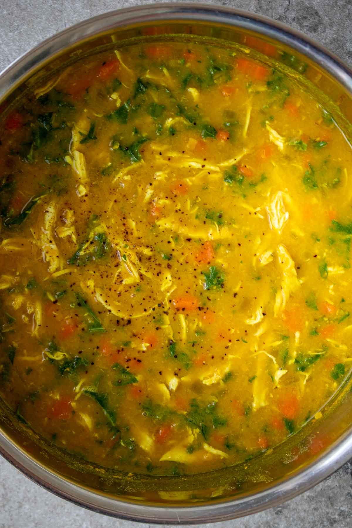 Cooked chicken lentil soup in a large pot.