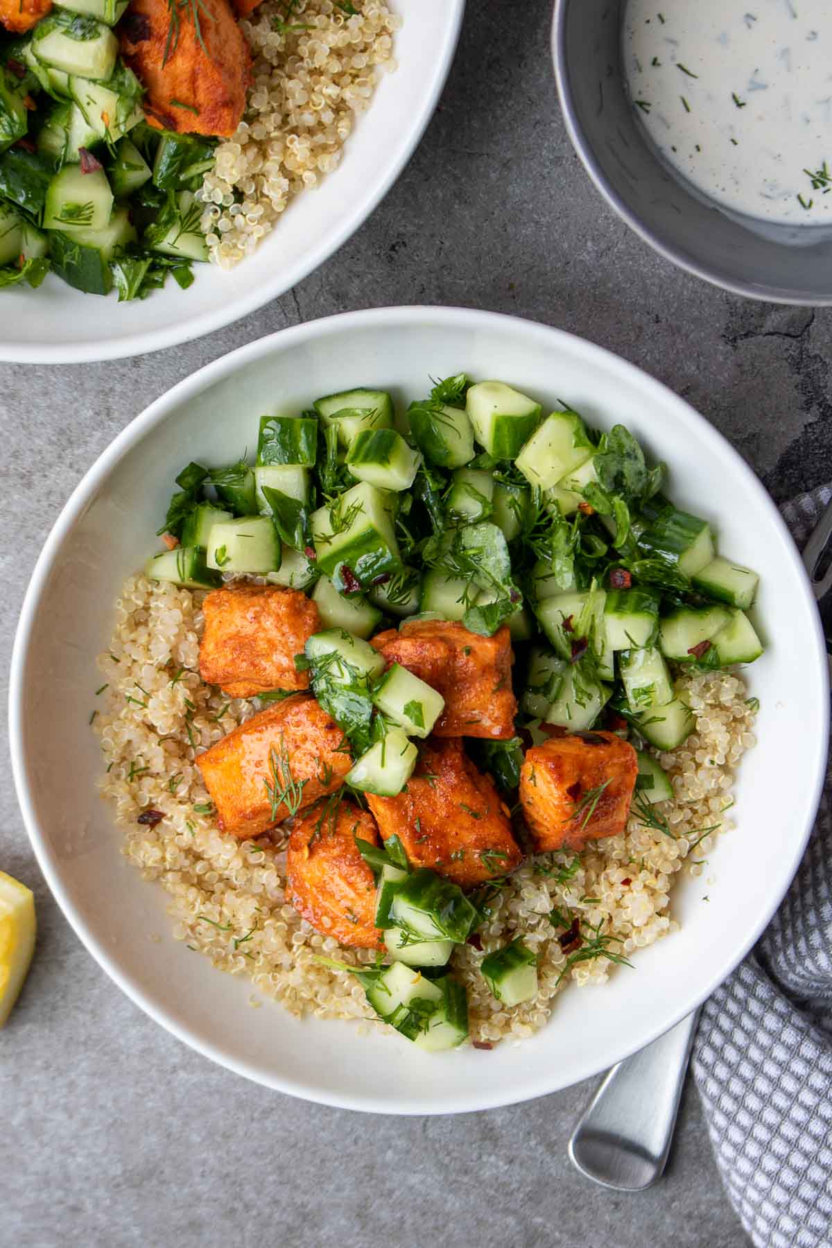 Bowls filled with quinoa and salmon.