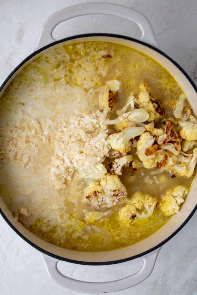 Soup broth with roasted cauliflower, parmesan cheese, and milk