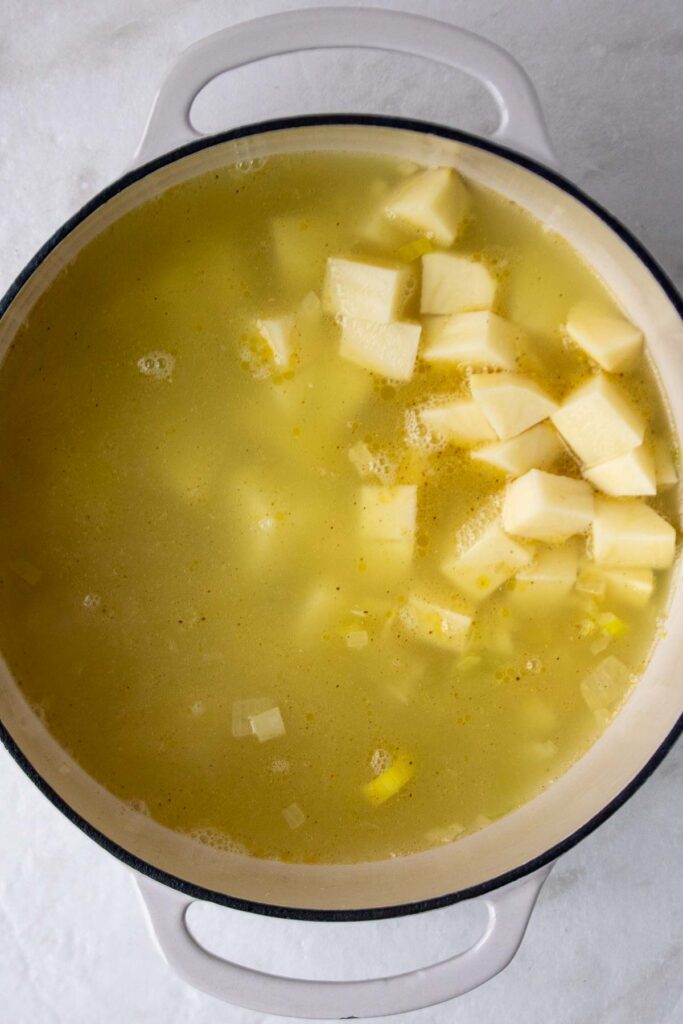 Soup broth with chopped potatoes