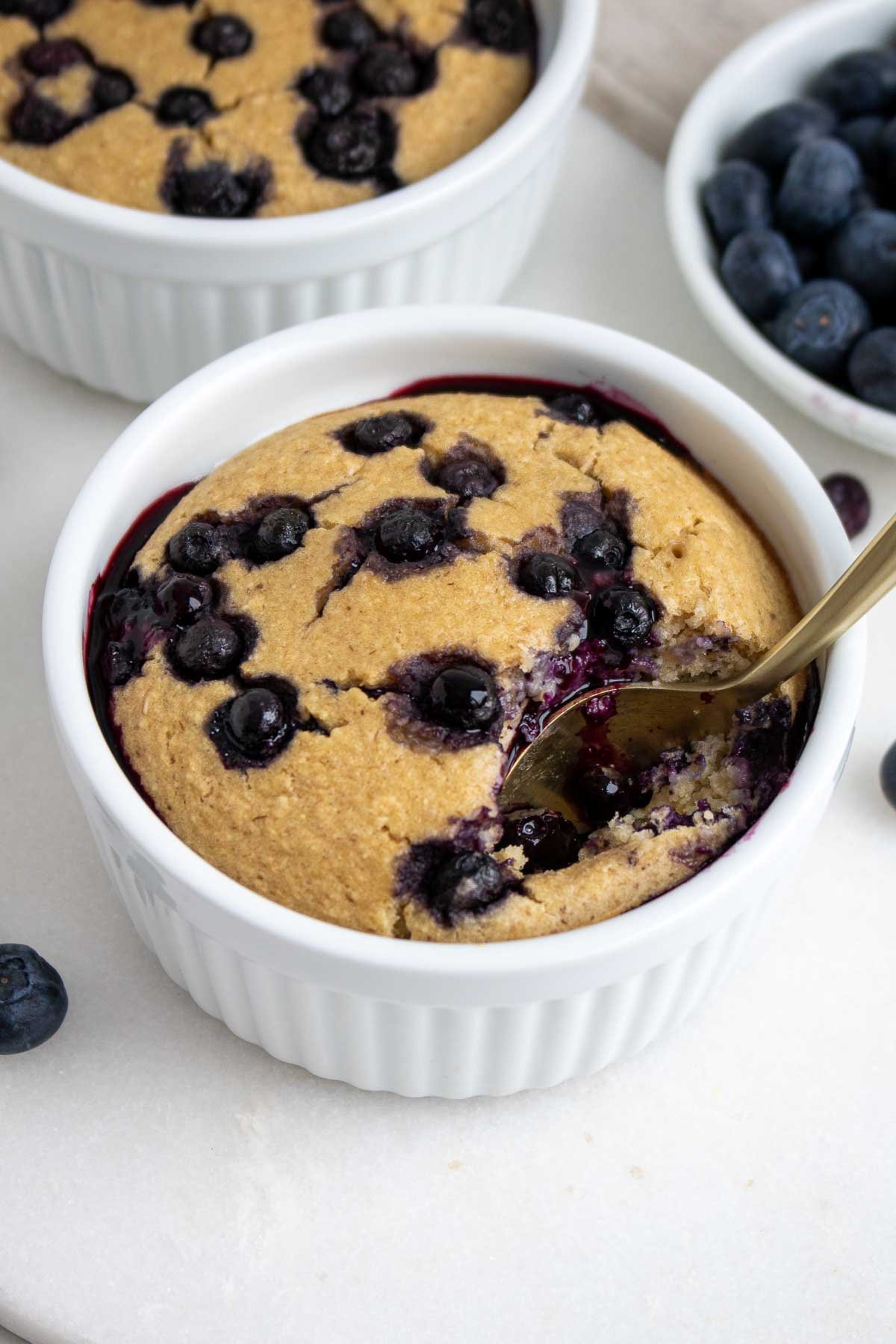 Ramekin with baked blended oats with a spoon