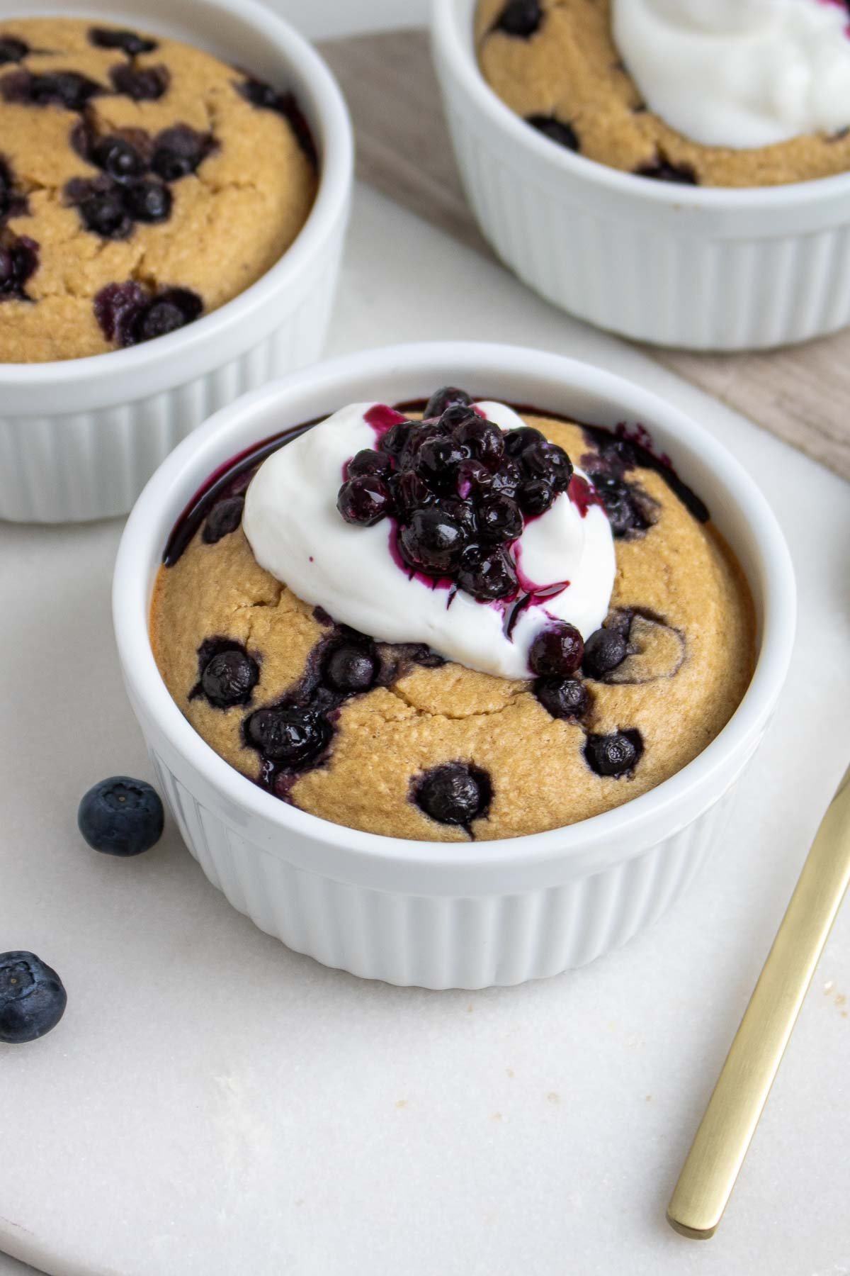 Ramekin with baked blended oats topped with Greek yogurt and blueberries
