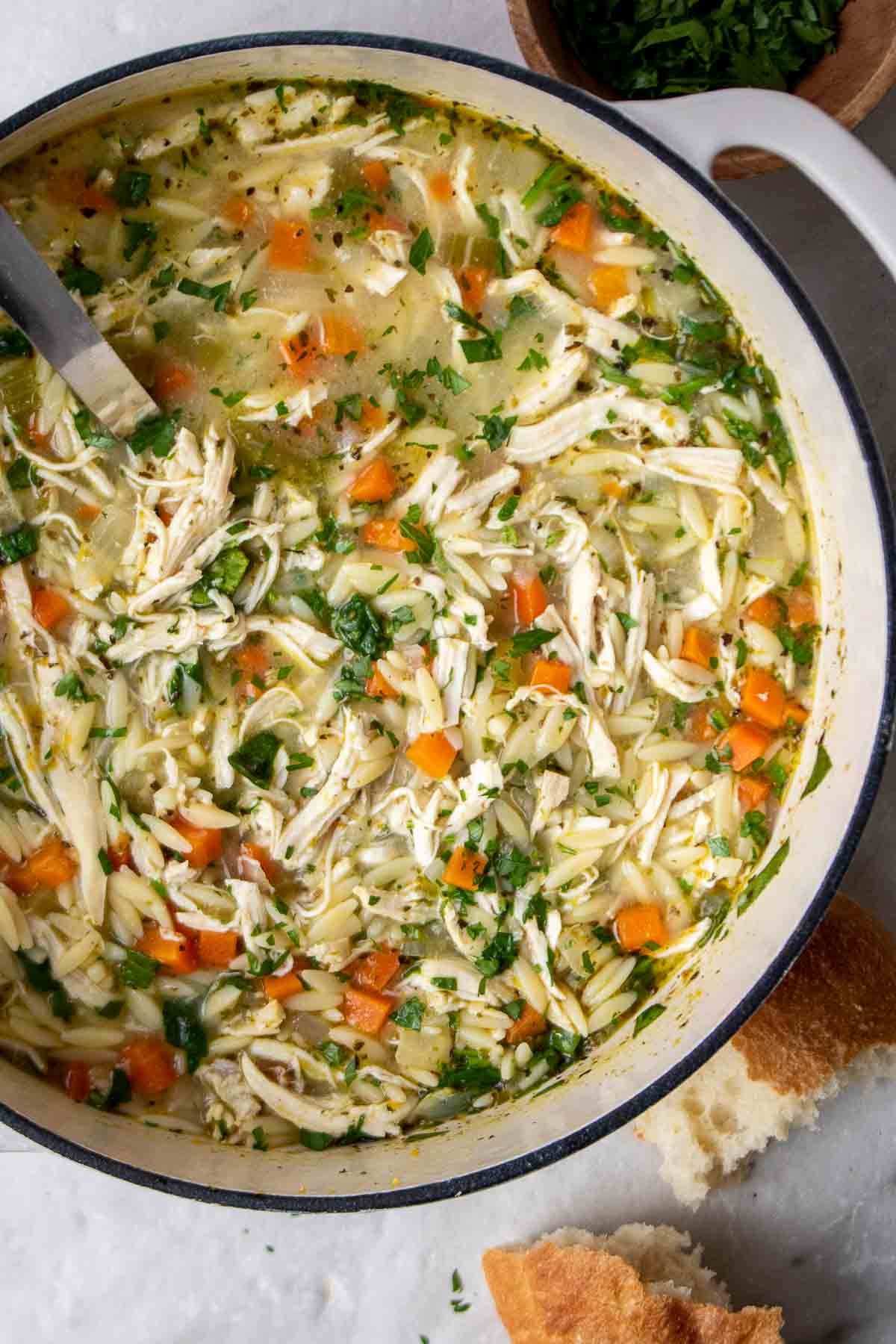 Cooked lemon chicken orzo soup in a pot