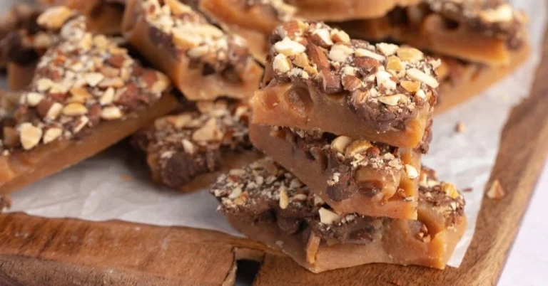 Homemade-Toffee-with-Chocolate-Chips-and-Almond-Nuts-in-a-Wooden-Board-1024×536