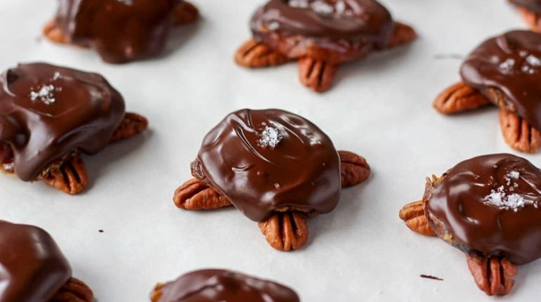 caramel center chewy texture. Dark Chocolate healthy recipe homemade turtles Medjool dates natural sweetener nutritious dessert Pecans toffee-like flavor 