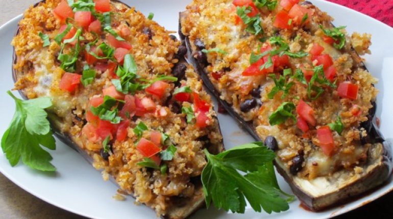 Baking black beans breadcrumbs butter Cheese chili flakes Cilantro Cooking cumin foil Garlic garnish golden hot or warm. ingredients meal medium eggplants olive oil Onion Parmesan parsley Preparation recipe instructions Rice stuffed eggplant Tomatoes vegetarian 