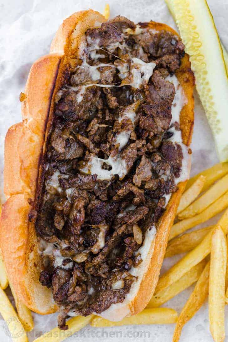 Philly cheesesteak sandwich with melted provolone cheese