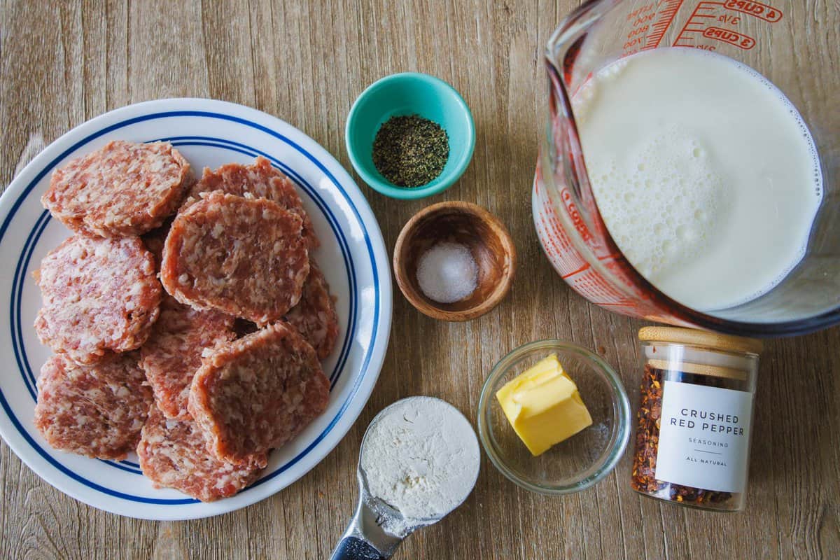 Ingredients for a Southern breakfast staple, including ground pork, salt, pepper, butter, flour, crushed red pepper, and milk