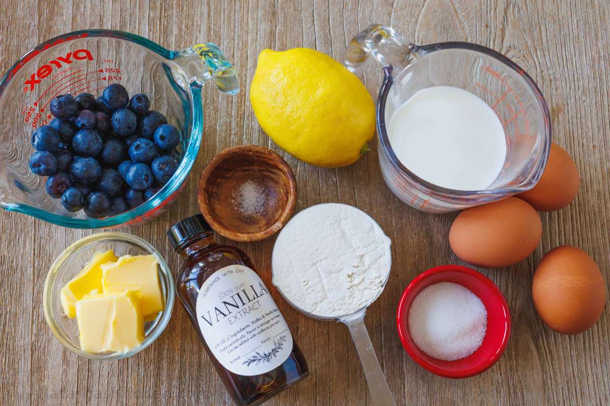 ingredients to make a lemon blueberry dutch baby with vanilla and powdered sugar