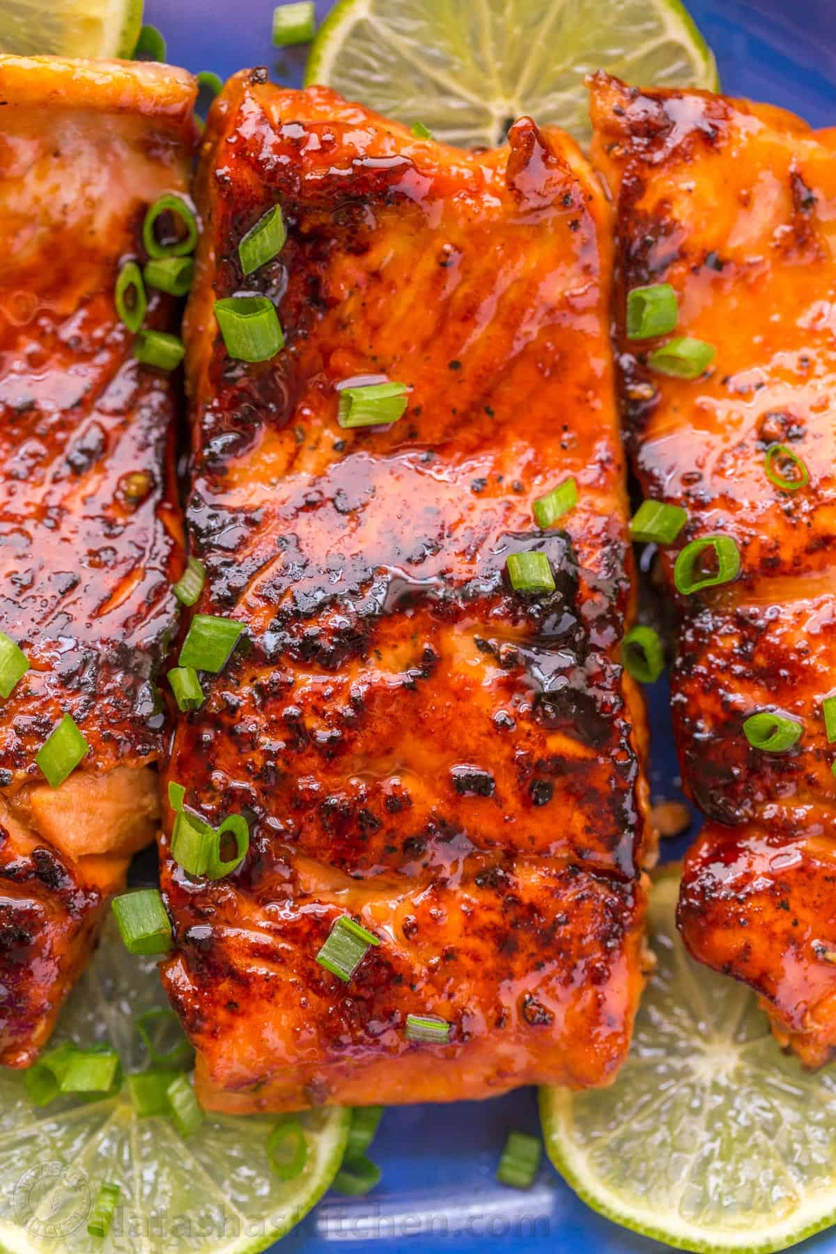 close up photo of honey glazed salmon served with chives