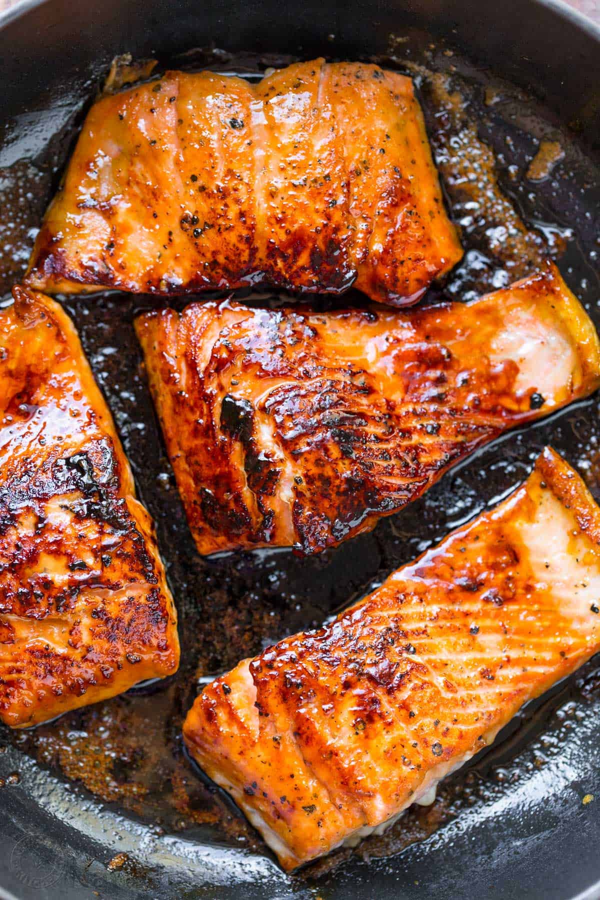 Our Honey-Glazed Salmon recipe cooking in a cast-iron pan