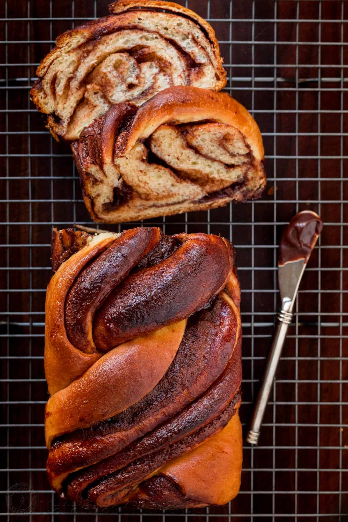 Overhead view of chocolate babka with two slices cut from one end.