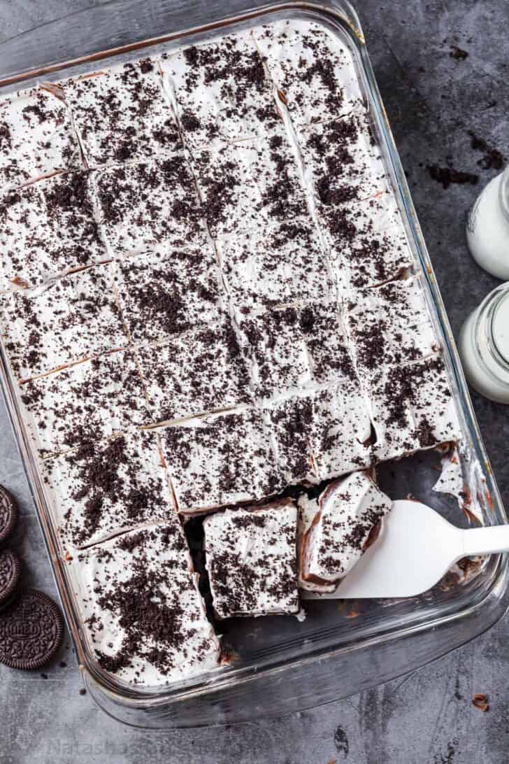 Chocolate lasagna in a glass casserole dish topped with crushed Oreos.