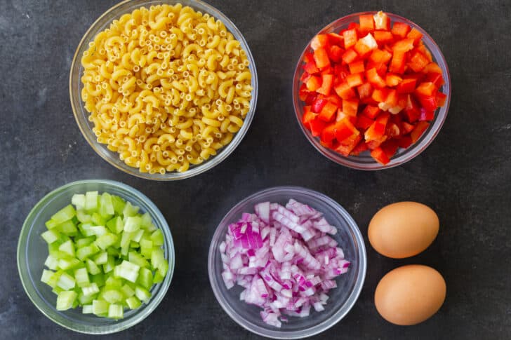 Ingredients for macaroni salad with elbow macaroni and vegetables