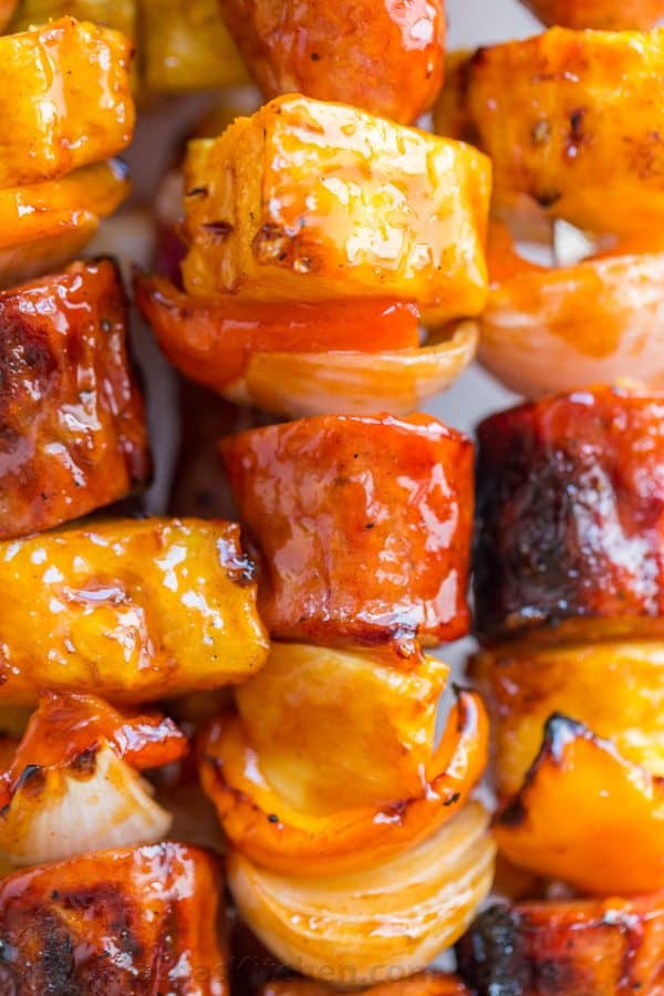 Grilled pineapple sausage skewers that are sweet, spicy, smoky, and incredibly flavorful! You won't believe how easy the glaze is. This fantastic brunch skewers recipe is brought to you by natashaskitchen.com.