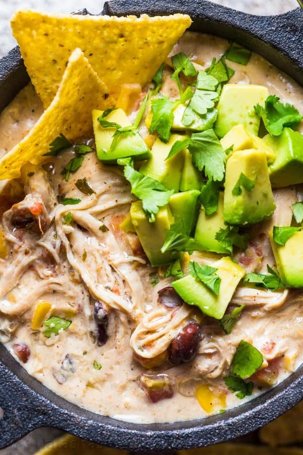 White Chicken Chili served with avocado and cilantro with tortilla chips