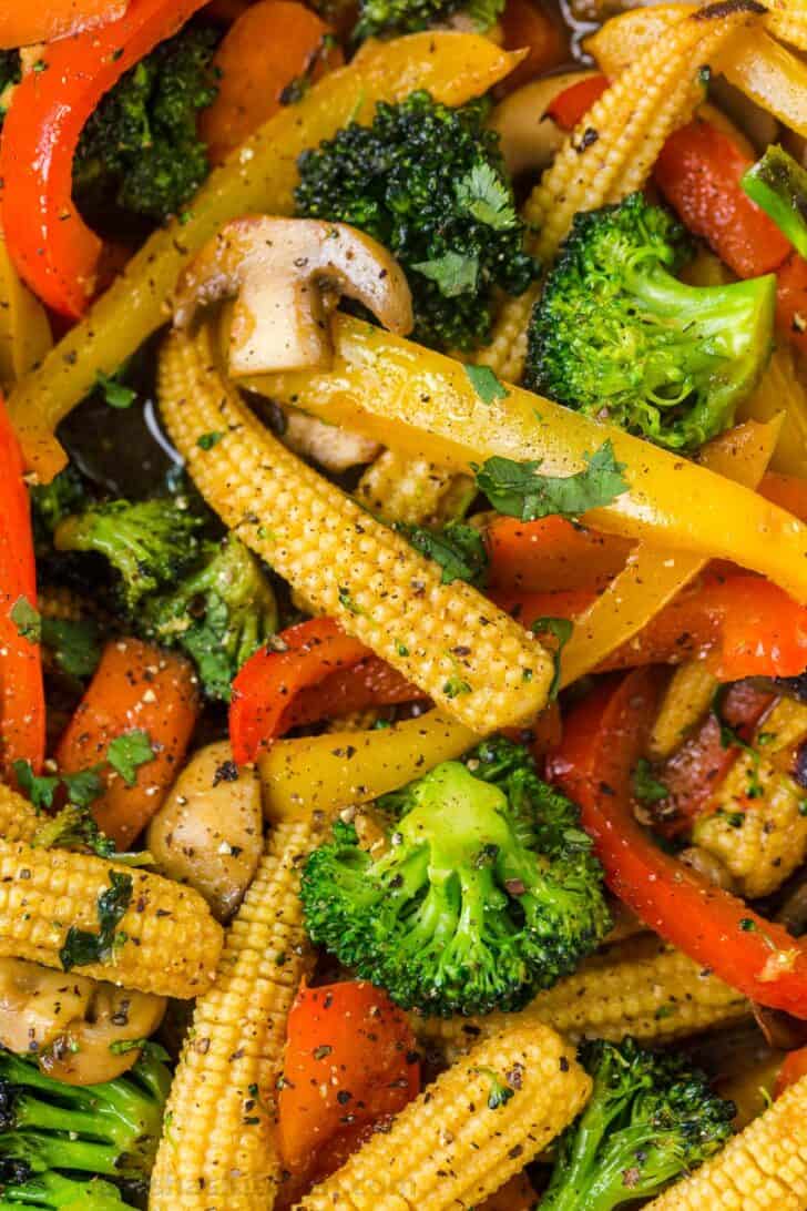 Sauteed vegetables in a sweet and savory stir fry sauce topped with pepper and greens.