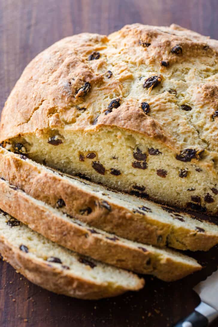 Perfectly baked Loaf of Irish soda bread sliced into pieces