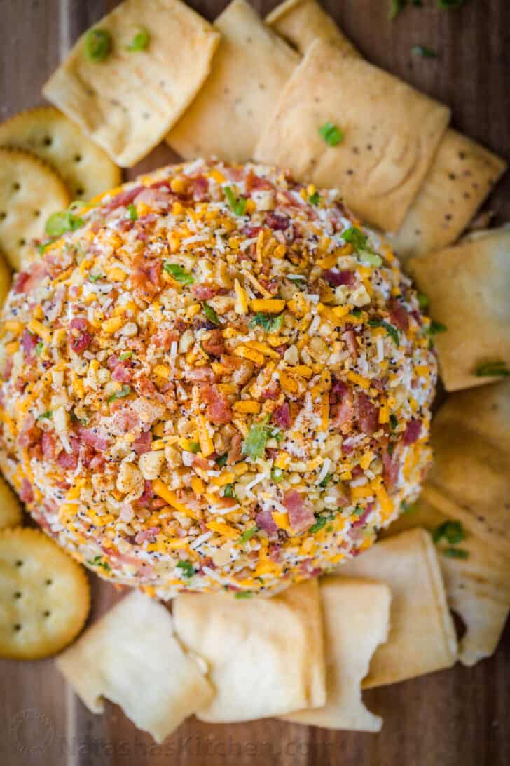 Cheese ball surrounded with crackers and pita chips.