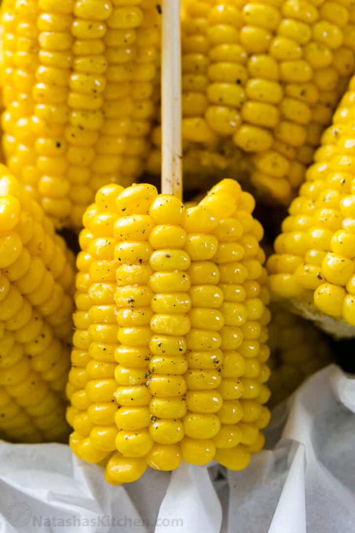 Close up of boiled corn on the cob with butter and black pepper
