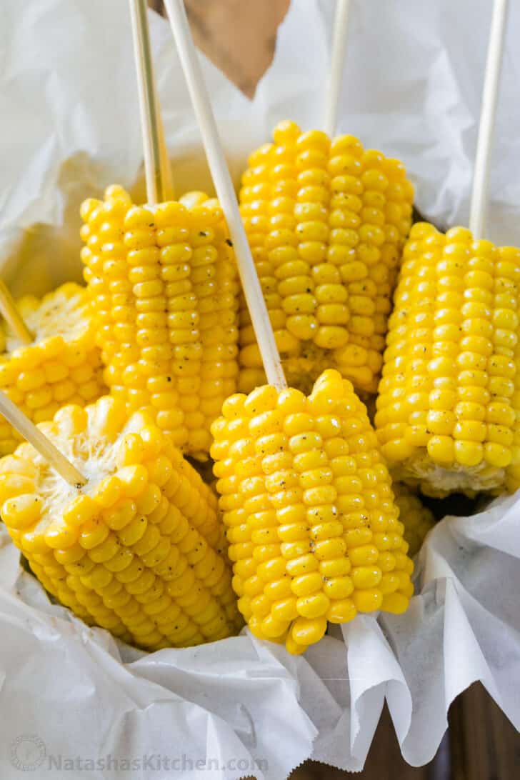 Boiled corn on the cob served on skewers