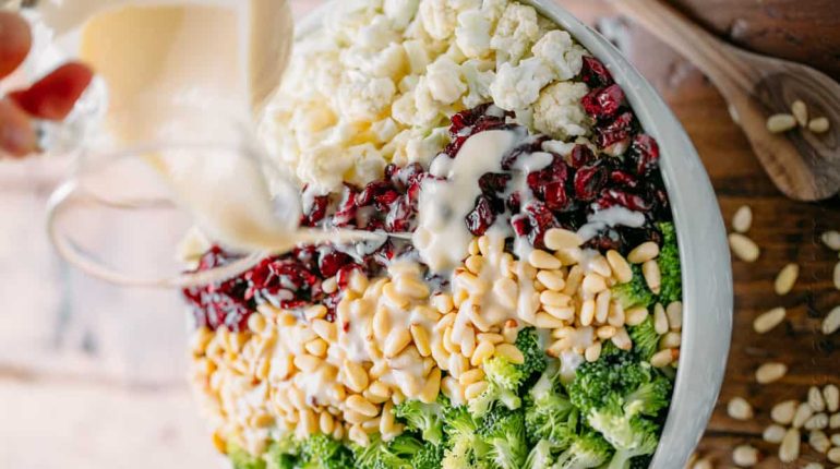 almonds Broccoli Broccoli Cauliflower Salad Cauliflower Christmas salad Creamy Salad dried cranberries Gluten-Free honey lemon dressing make-ahead party pine nuts potluck Recipe 