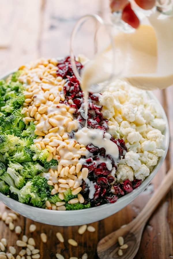 Broccoli cauliflower salad in bowl with creamy dressing