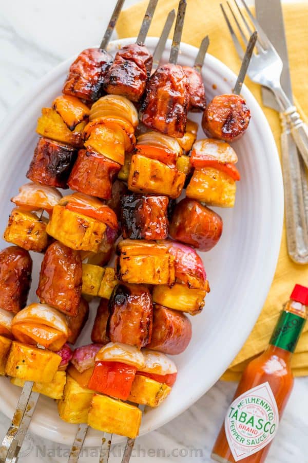 Grilled pineapple sausage skewers that are sweet, spicy, smoky, and incredibly flavorful! You won't believe how easy the glaze is. This fantastic brunch skewers recipe is brought to you by natashaskitchen.com.