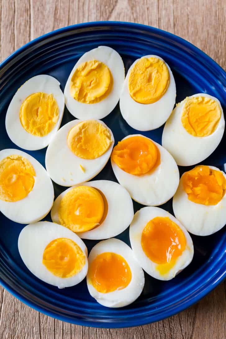 boiled eggs on a platter with hard boiled eggs, medium boiled eggs and soft boiled eggs