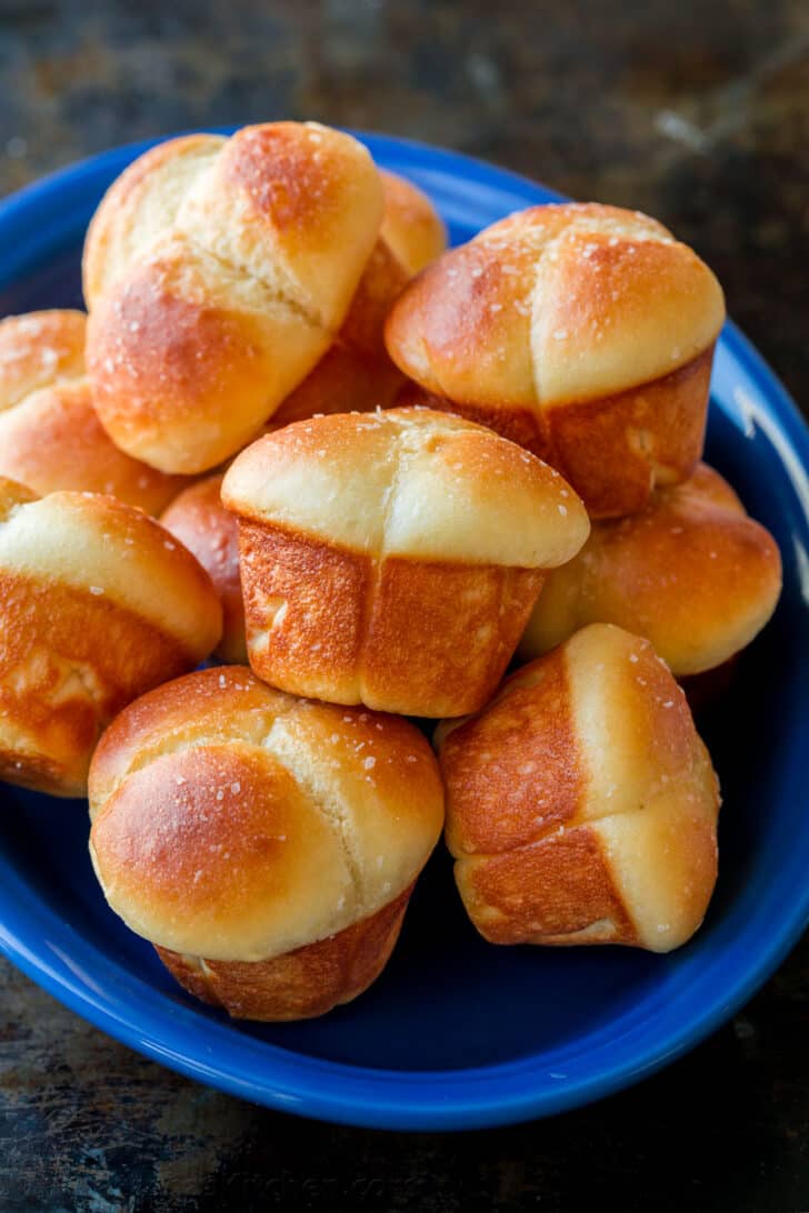 Soft Cloverleaf Dinner rolls on blue platter