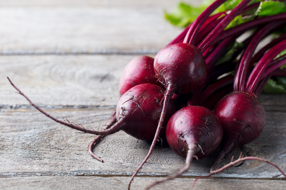 Fresh organic beet, beetroot. Grey rustic wooden background. Close up.